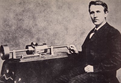 Thomas A. Edison sitting by his invention, the Phonograph, 1878 by American Photographer